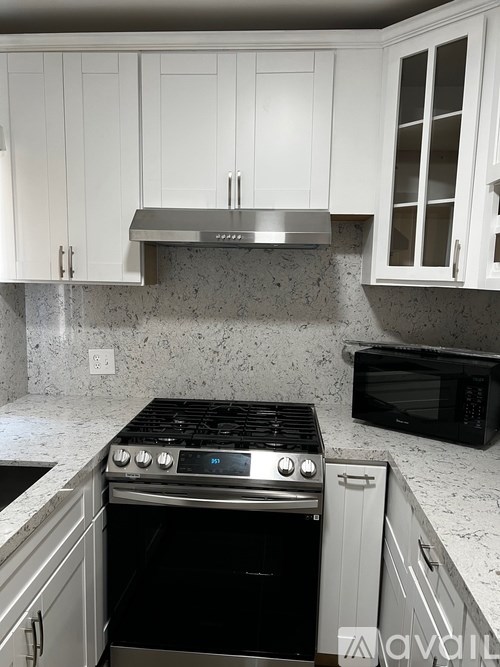 A kitchen with a stove top oven and microwave.