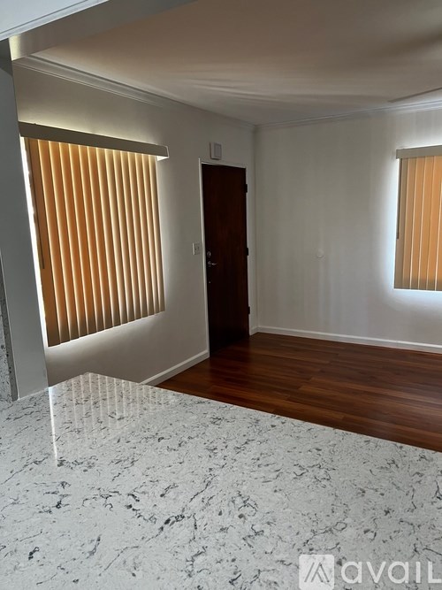 A room with a wooden floor and a door.