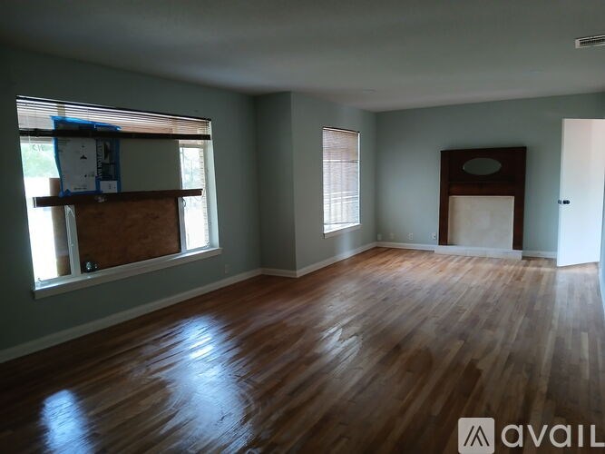 A room with wooden floors and a white ceiling.