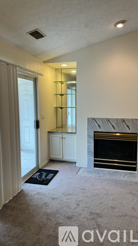 A room with a fireplace and a mirror on the wall.
