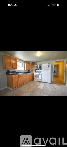 A bathroom with red tiles and a wooden vanity.