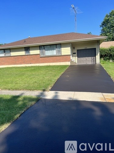 A house with a driveway in front of it.