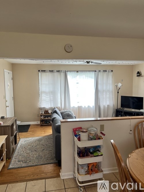 A living room with a couch, chair, and television.