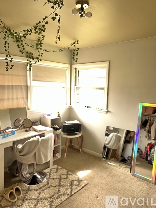 A room with a desk, chair, and a mirror on the wall.