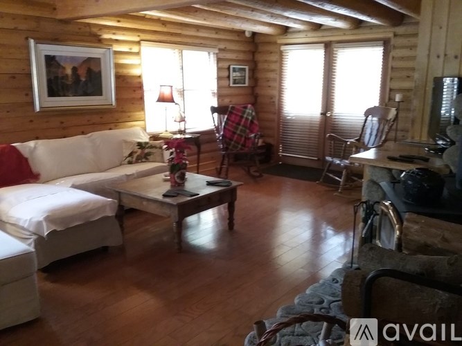 A living room with a couch, chair, and table.