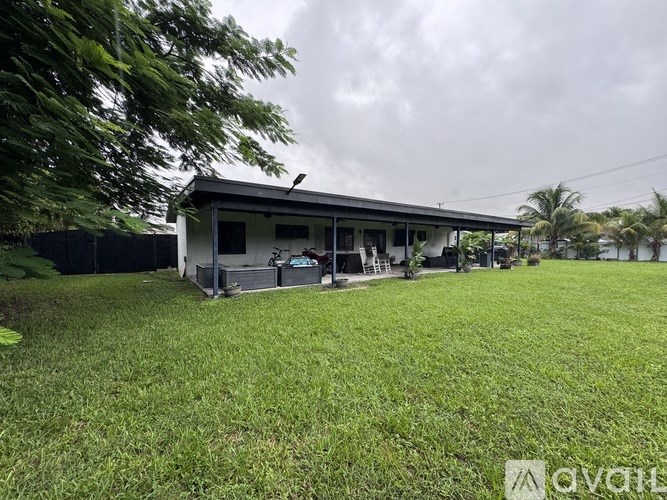 A house with a green lawn in front of it.