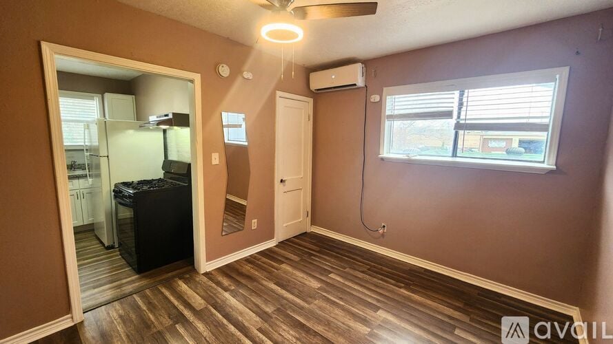 A room with brown walls and wooden flooring is available for rent.