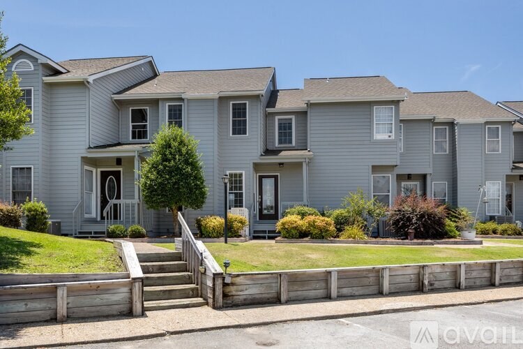 A row of houses with a wooden fence in front.