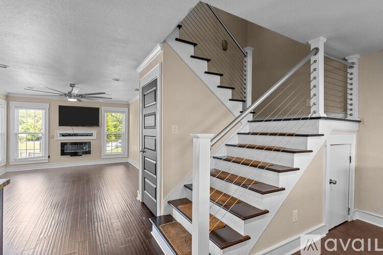 A staircase with wooden steps and white railings.