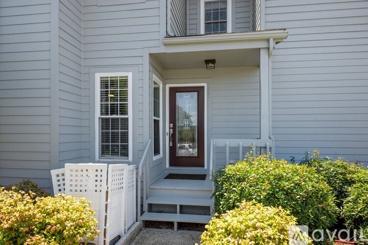 A house with a front porch and a white picket fence.