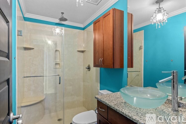 A bathroom with a blue wall and a white toilet.