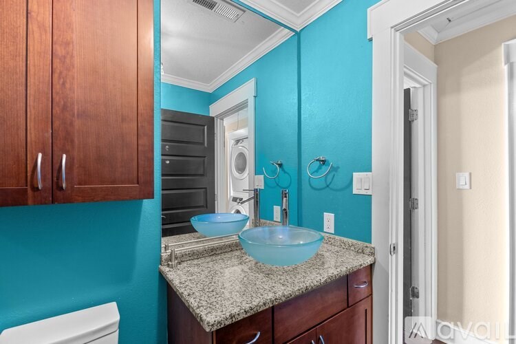 A bathroom with a blue wall and a white toilet.