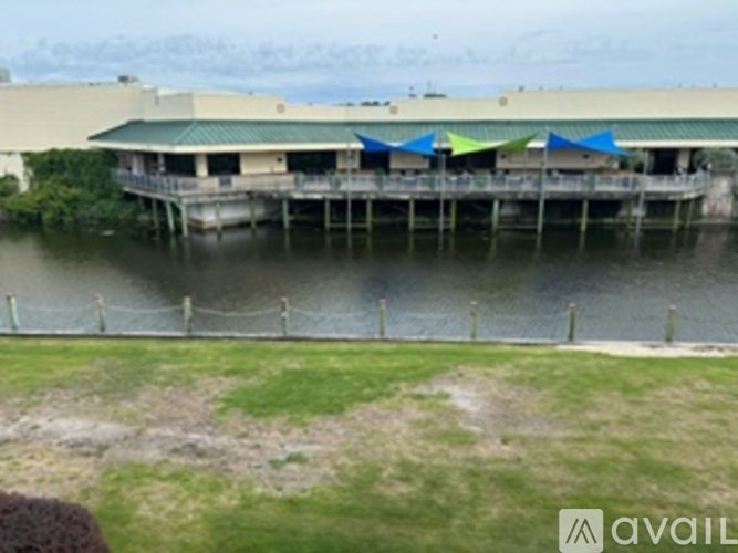 A building with a green roof is situated on a body of water.