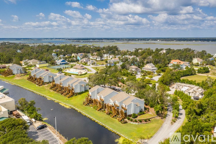 A bird's eye view of a residential area with houses and a river.