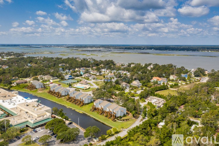 A bird's eye view of a residential area with a river running through it.