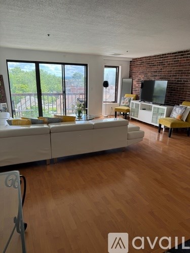 A living room with a white couch and a television.