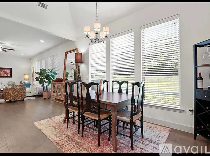 A dining room with a table set for six.