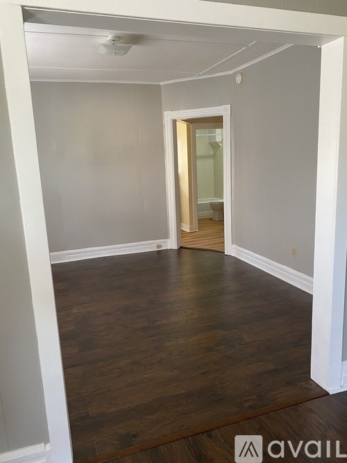 A room with wooden floors and white walls.