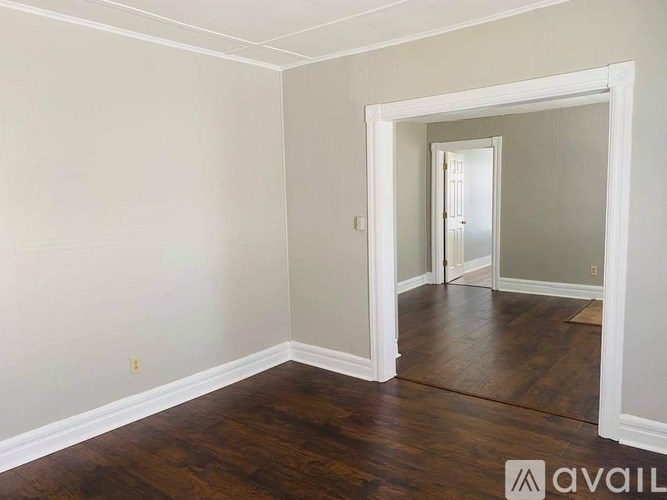 A room with wooden floors and white walls.