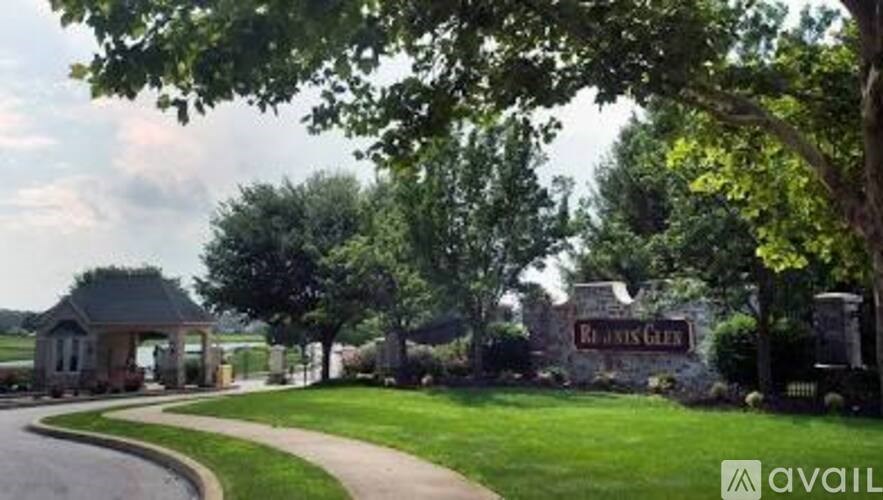 A sign that says "Ranch Style" is in front of a grassy area.