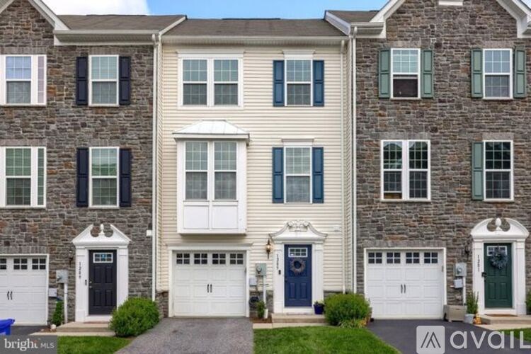 A row of houses with garages and driveways.