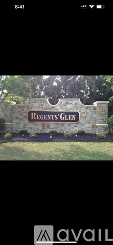 A stone wall with a sign that says Regents Glen.