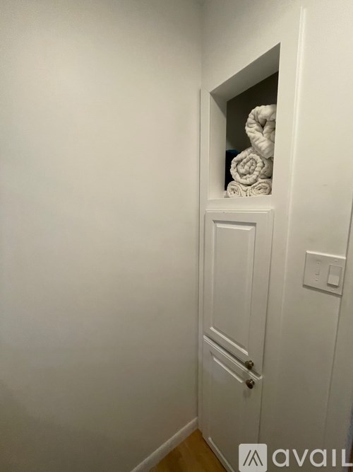 A white door with a mirror above it.
