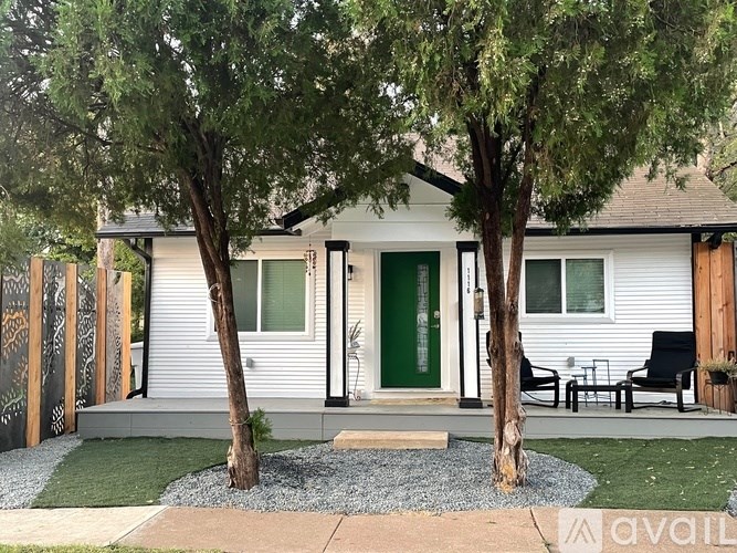 A house with a green door and a small front yard.