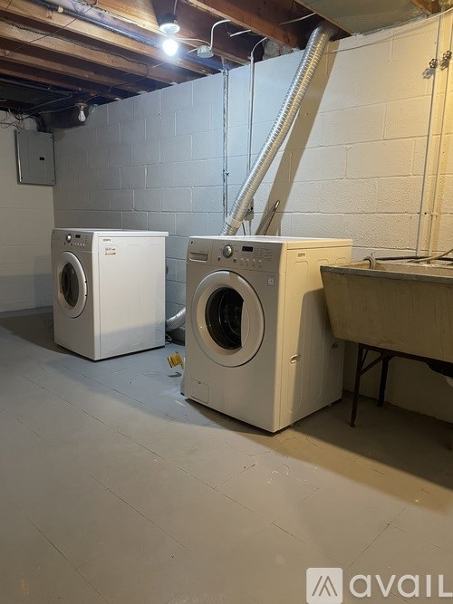 Two front load washing machines in a laundry room.