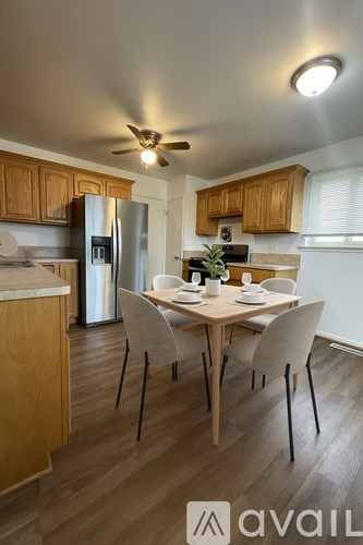 A kitchen with a table and chairs in the middle of the room.