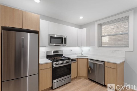 A modern kitchen with wooden cabinets and stainless steel appliances.