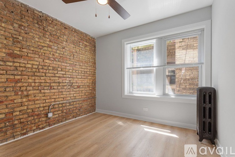 A room with a brick wall and a window.