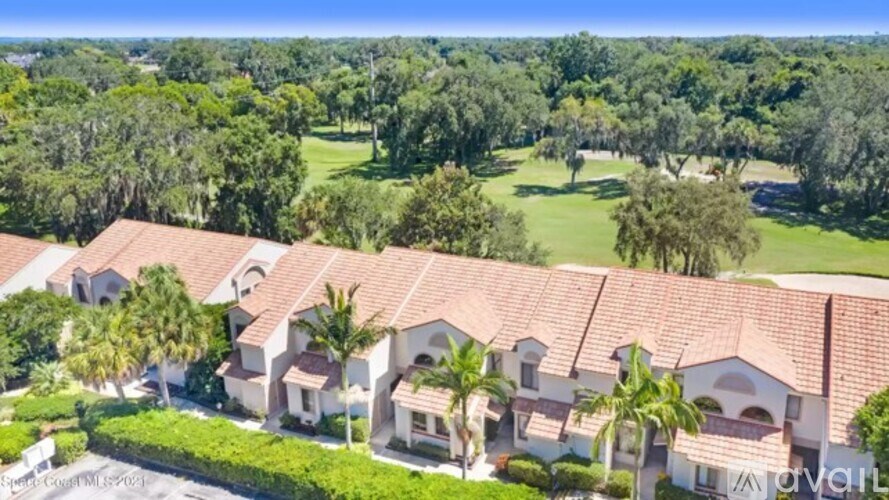 A row of houses with red roofs and white walls.