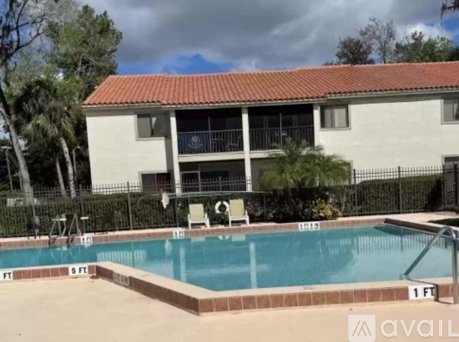 A pool in front of a house with a sign that says "available".