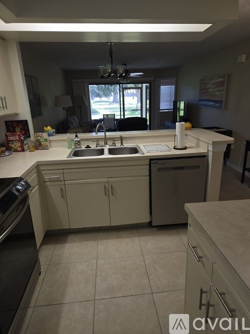 A kitchen with white cabinets and a sink.