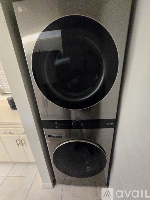 A modern stainless steel dishwasher with the door open.