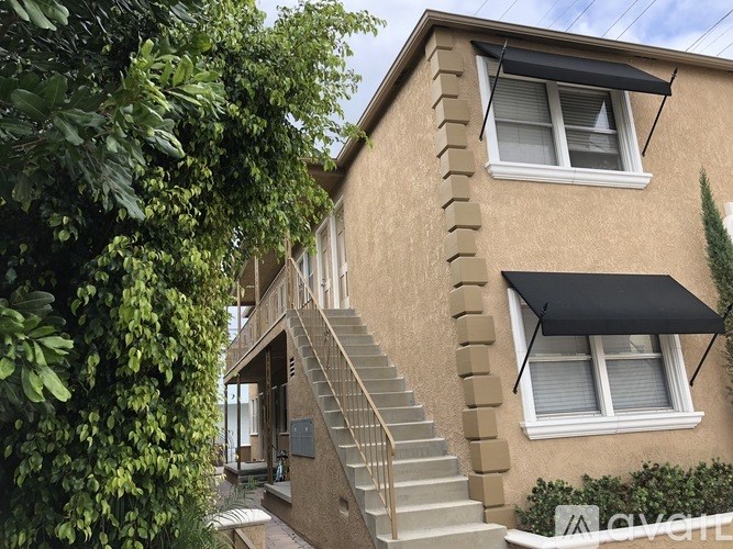 A house with a staircase leading to the front door.
