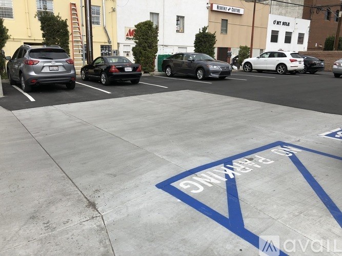 A parking lot with a blue arrow on the ground.