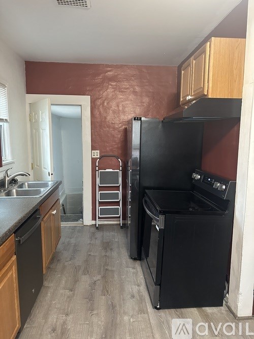 A room with grey carpet and two doors.