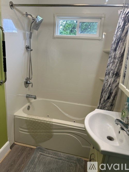 A bathroom with a tub, shower, and sink.