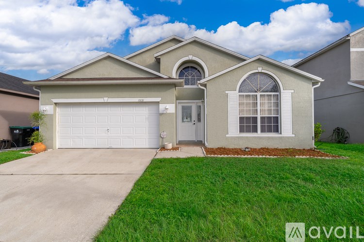 A house with a garage and a driveway is available for sale.