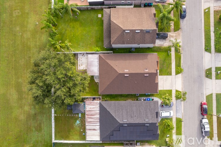 A bird's eye view of a residential area with houses and cars.