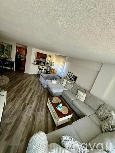 A living room with a grey couch and a coffee table.