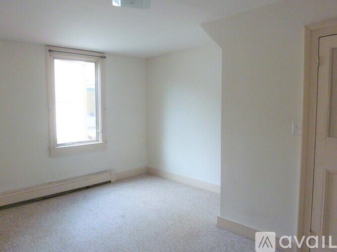 A white room with a window and a door.