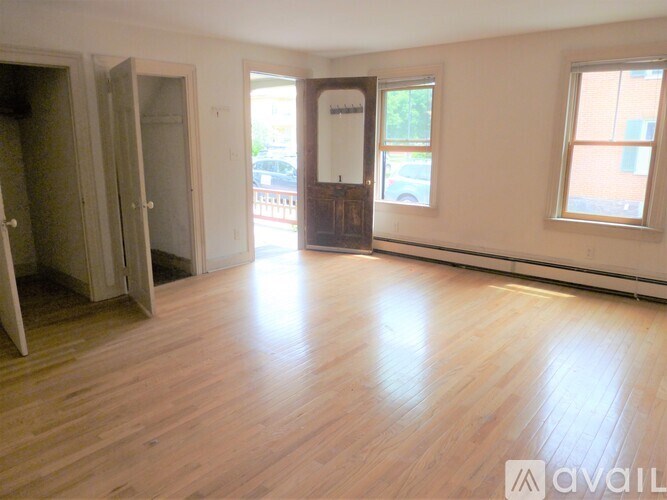 A room with wooden floors and a large window.