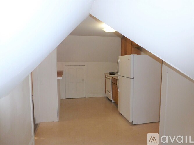A kitchen with white appliances and cabinets.