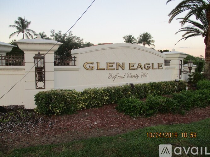 The sign of Glen Eagle Golf and Country Club is displayed in front of a building.