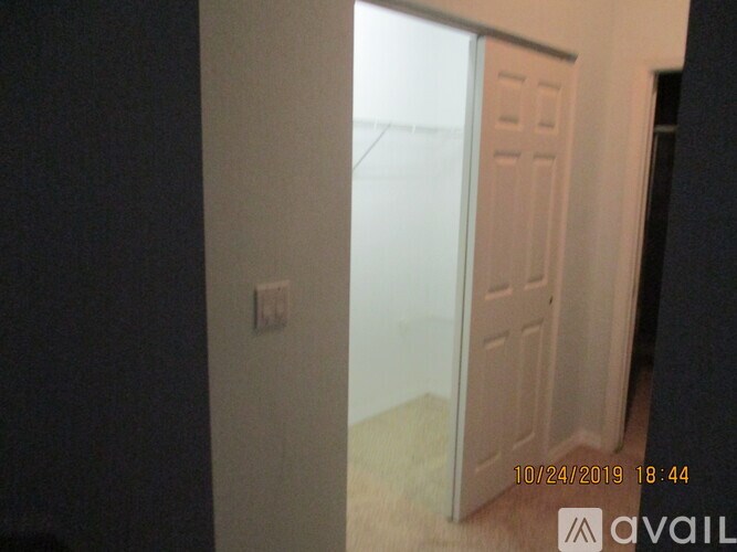 A white door is open in a room.