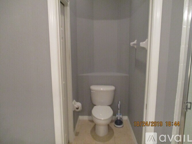 A white toilet in a small bathroom.
