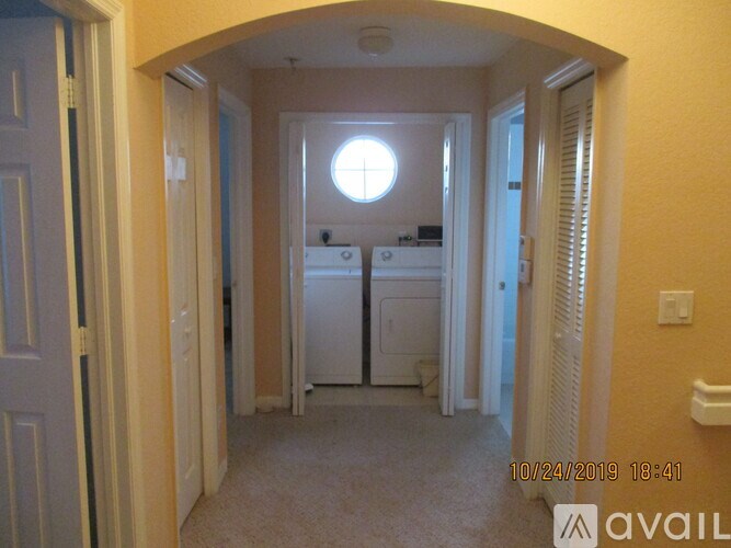 A small room with a window and a fridge.